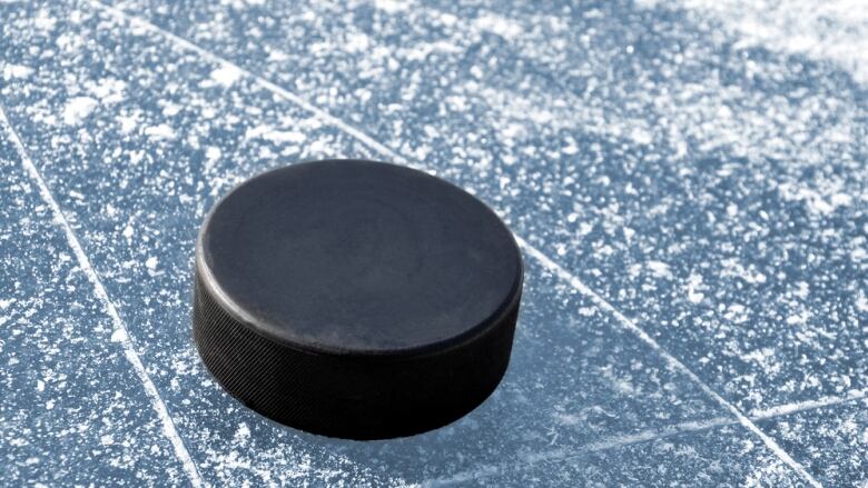 A hockey puck on an ice rink.