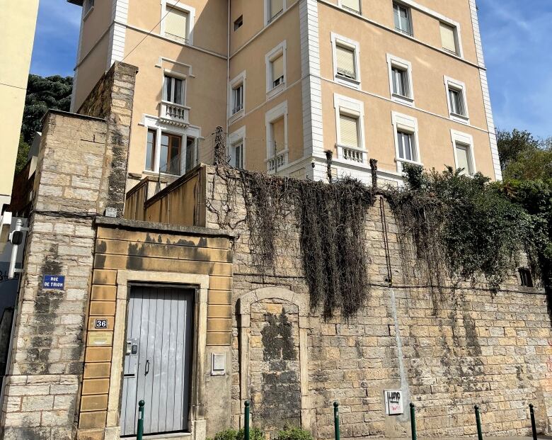 A building behind a stone wall.