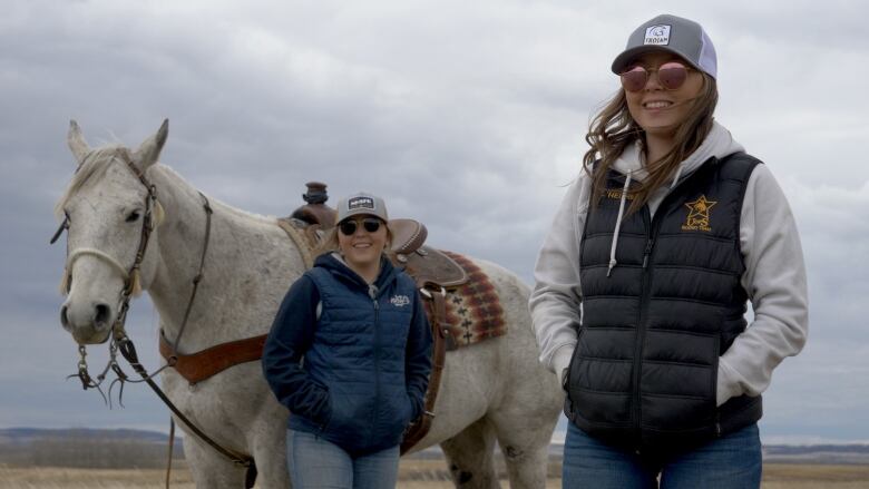 Mackenzie and Taylor L'Heureux with their horse on their grandparent's farm in North Battleford, Sask.