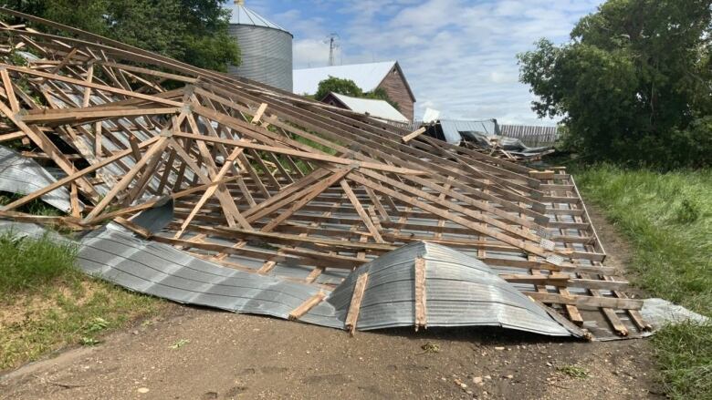 A farm structure damaged by a tornado.