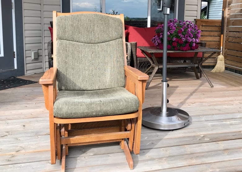 A photo of a rocking chair in a garage.