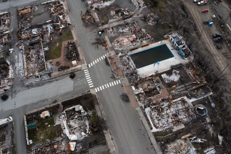 An aerial photo showing the devastation caused by the wildfire, with nearly every lot razed and scorched.