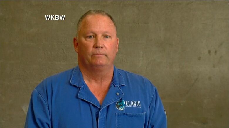 A man in a blue polo shirt.