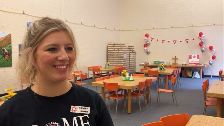 Lauren Goerz stands in front of set tables at the drop in centre in Lower Sackville, N.S. 