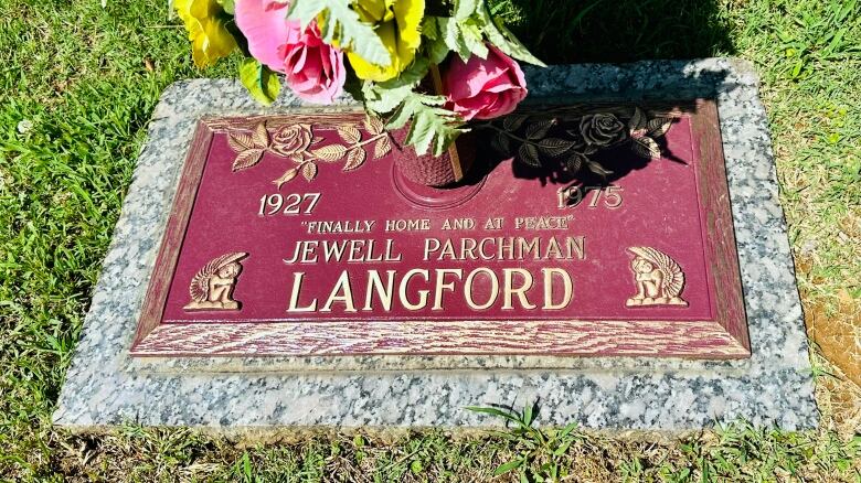 A gravestone in the grass.