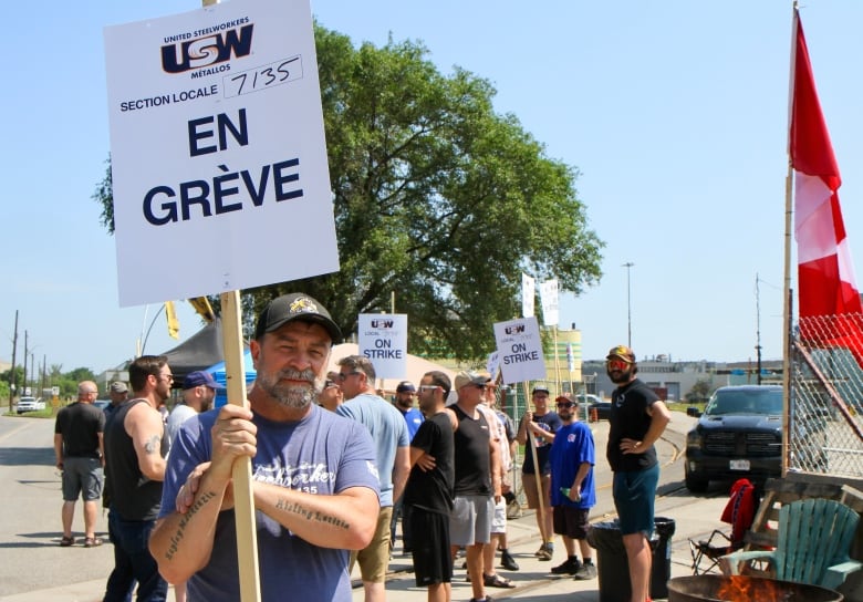 man holds sign