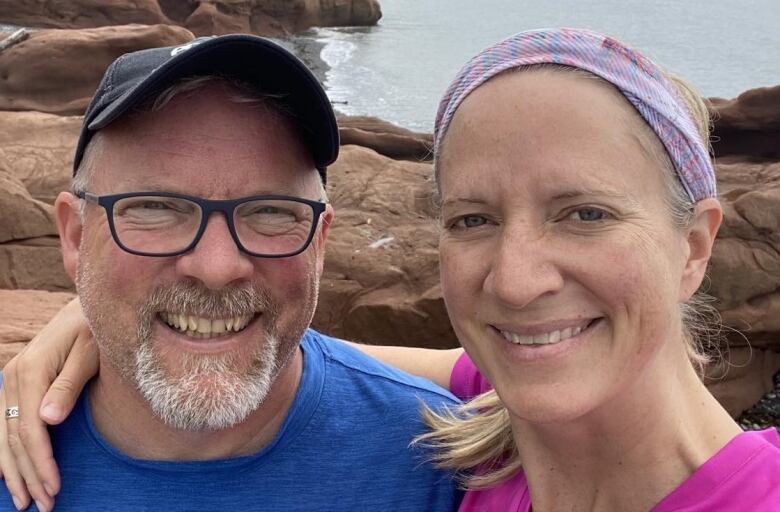 Terence and Carala pose for a selfie on a Maritime beach. 