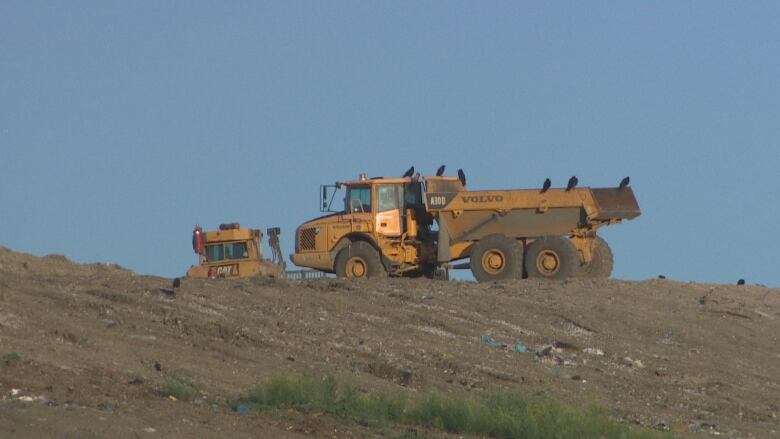 Truck and tractor seen from a distance.