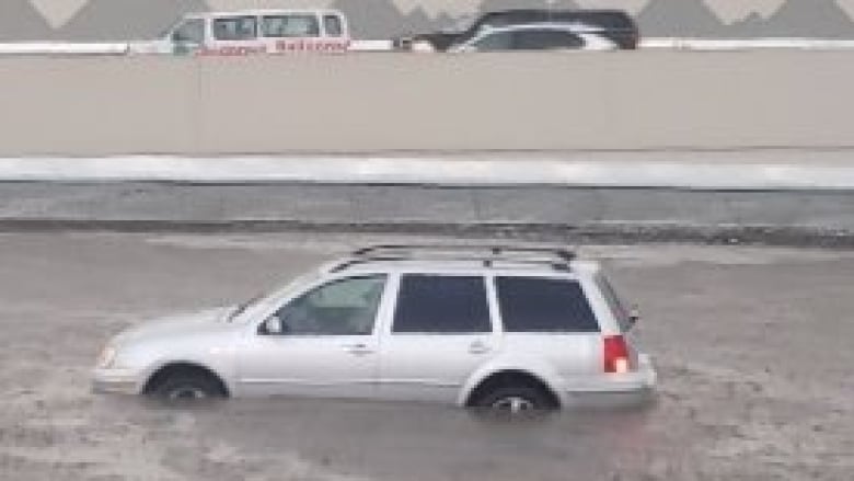 A car caught in a flood on the road