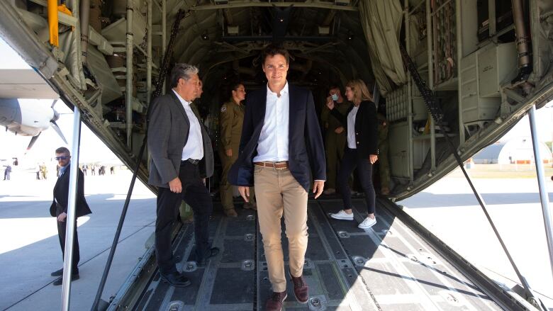 Prime Minister Justin Trudeau walks off a C130 after saying goodbye to NATO Secretary General Jens Stoltenberg at 4 Wing Cold Lake air base in Cold Lake Alta, on Friday August 26, 2022.