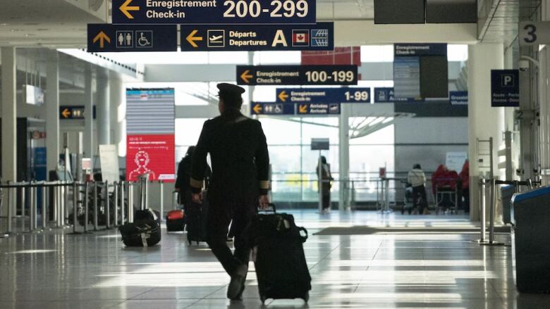 Man pulls luggage at Montreal Trudeau International Airport