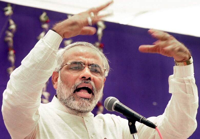 An Indian politician gestures to a crowd.