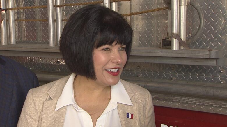 Ginette Petitpas Taylor chats with a CBC reporter.