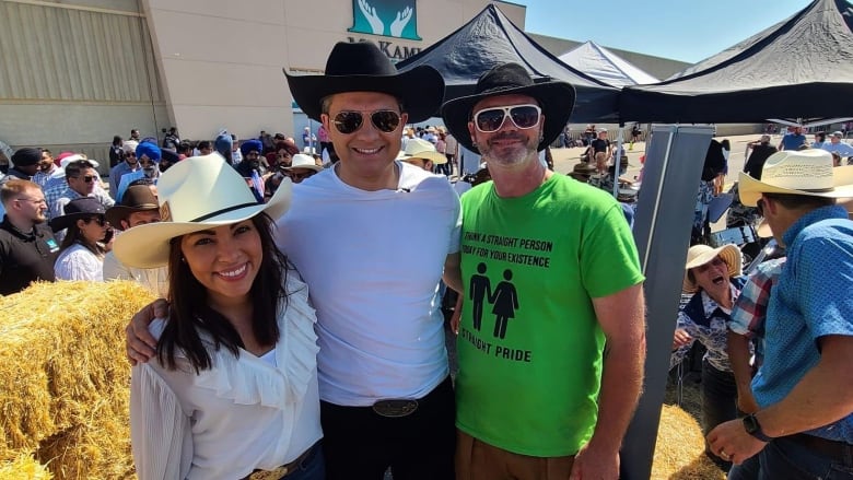 Federal Conservative Leader Pierre Poilievre and his wife, Anaida, pose for a photo with an unidentified man wearing a 