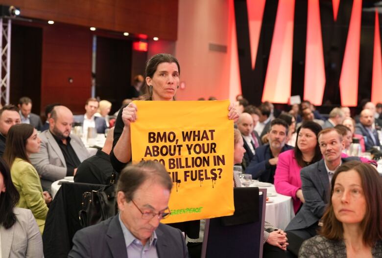 Protesters from Greenpeace interrupt a luncheon speech by Gregoire Baillargeon (not shown), president of BMO Financial Group Quebec, at the Montreal Chamber of Commerce in Montreal on May 10, 2023.