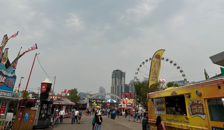 Haze is seen over a ferris wheel and food vendors at the Calgary Stampede. 