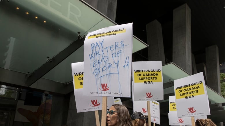 Members of the Writers Guild of Canada (WGC) rally outside the Toronto offices of Apple and Amazon on June 14, 2023. 