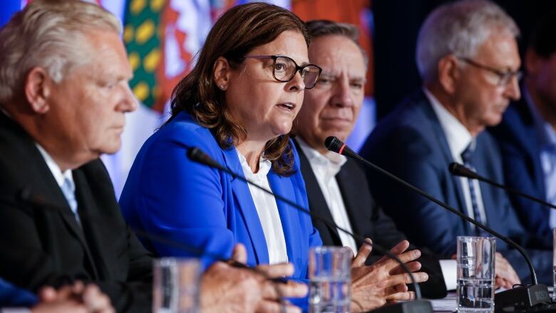 Doug Ford, premier of Ontario (left), and Francois Legault, premier of Quebec, listen in as Manitoba Premier Heather Stefanson (second from left), chair of the Council of the Federation, speaks to media during the closing news conference at the Council of the Federation Canadian premiers' meeting at The Fort Garry Hotel in Winnipeg on July 12, 2023.