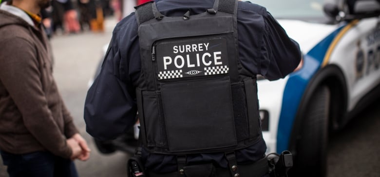 A navy blue police uniform is pictured with the words 