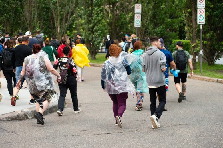 people leaving a music festival in the rain