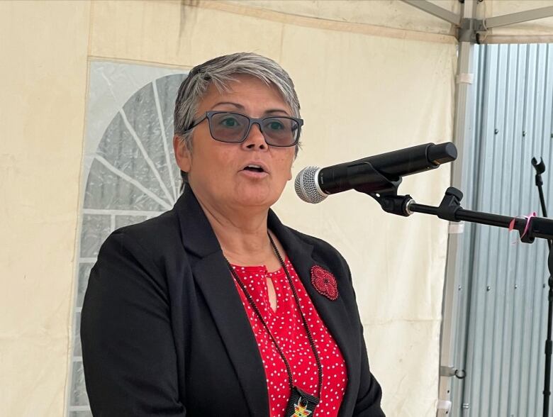 A woman speaking on a microphone.