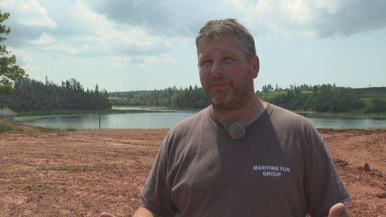 Matthew Jelly talks to a CBC reporter on a sunny day.