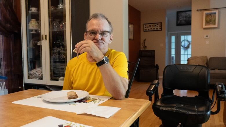 A man holds a sandwich in his hand.