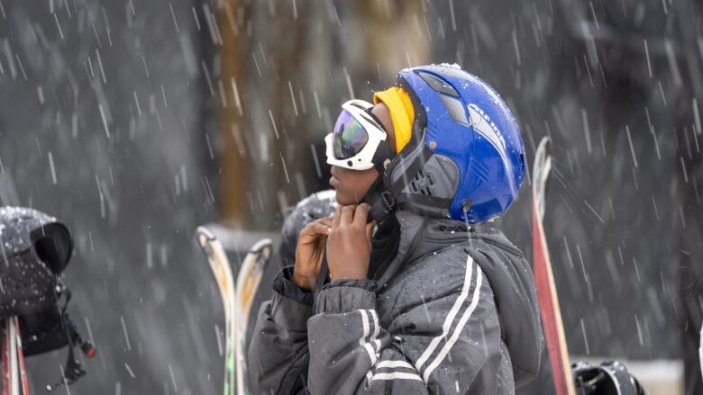 A young skier adjusts his helmet at the Afriski ski resort near Butha-Buthe, Lesotho, Saturday July 30, 2022. While millions across Europe sweat through a summer of record-breaking heat, Afriski in the Maluti Mountains is Africa's only operating ski resort south of the equator. It draws people from neighboring South Africa and further afield by offering a unique experience to go skiing in southern Africa.