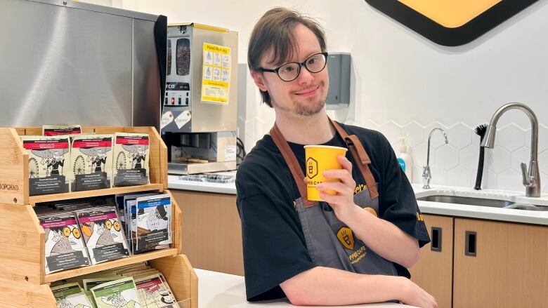 Dylan Harman, an employee at Lil E Coffee Cafe, says he cried tears of joy when he found out he got the job. He says he loves to serve customers coffee and see them smile.