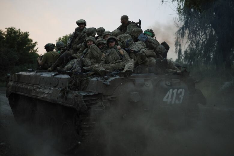 Ukrainian servicemen ride atop on an APC at the frontline near Bakhmut, Donetsk region, Ukraine, Thursday, June 29, 2023. Ukrainian forces are making steady progress along the northern and southern flanks of Bakhmut, in a semi-encirclement of the wrecked city that Russian forces have been occupying since May. 