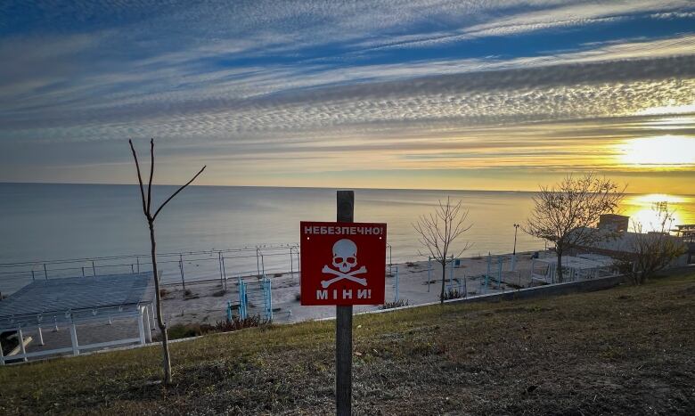 A sign features a skull and crossbones with the words, 