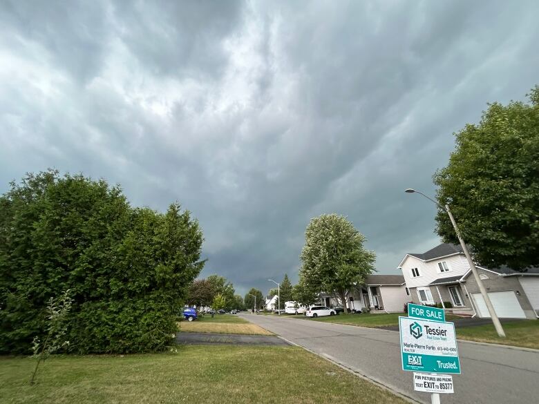 A dark sky over a rural town. 