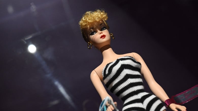 The first Barbie Doll from 1959, featuring a blonde ponytail and a portfolio of fashion sketches, was seen by some as progressive and independent, while others were critical of the doll's slim frame.