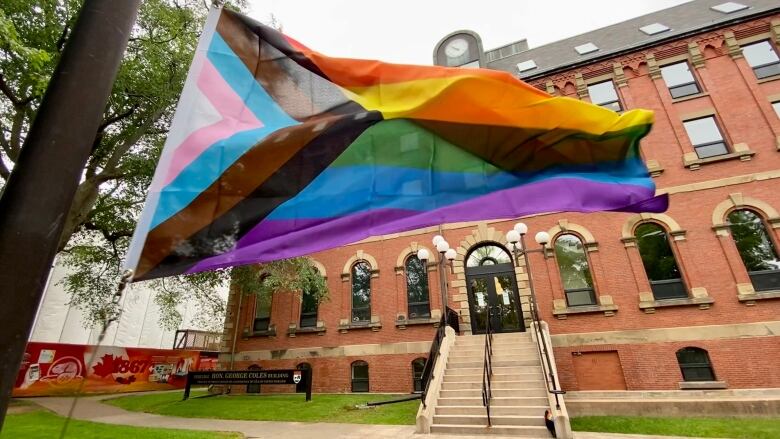 A flag raising of the progress pride Flag outside the George Coles building with government leaders in attendance. 