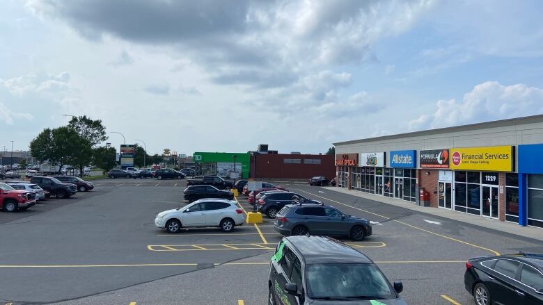 A parking lot with cars and buildings.