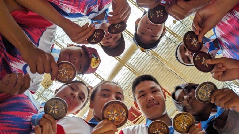 Group of young people with medals.