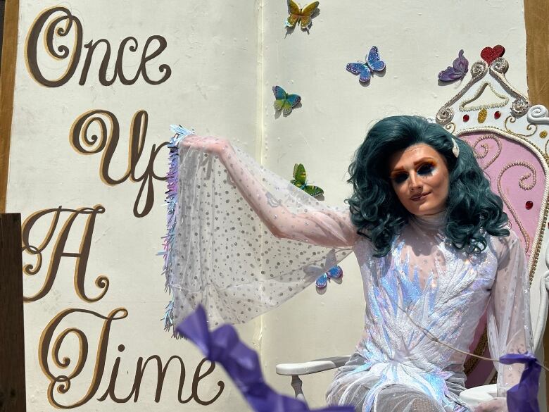 Miss Shaneen claims to be London's youngest drag queen. Their float was a portable drag queen story time setup, complete with chairs for listeners and a giant book adorned with butterflies next to a bejeweled rocking chair.