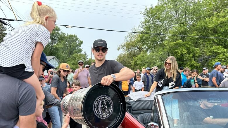 A man with a silver trophy 