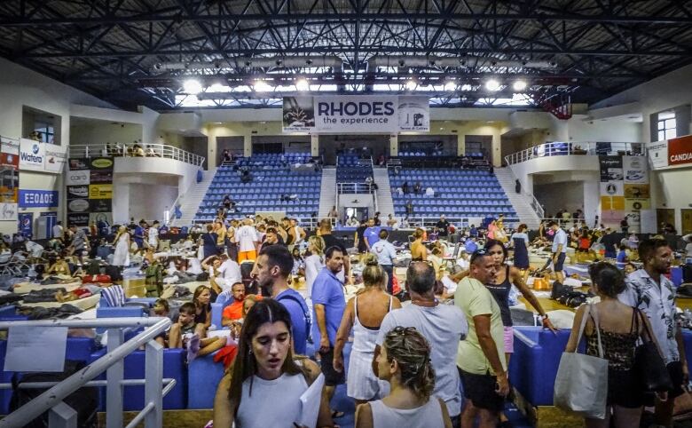 Evacuees gather in a stadium.