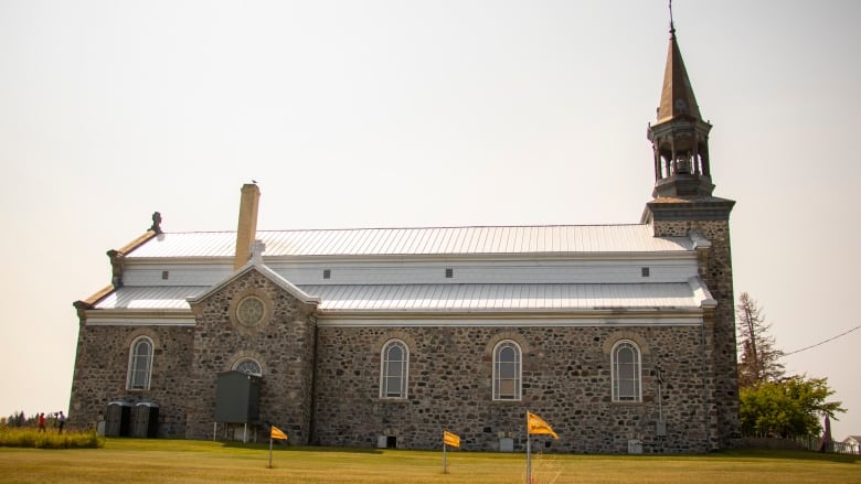 A giant stone church sits in the praries.