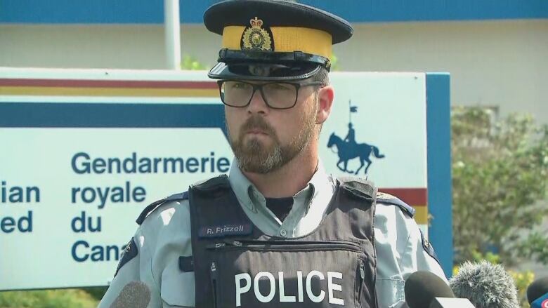 Man in a police uniform in front of a podium.