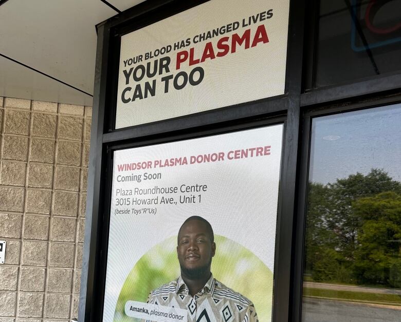 Sign on the front door at the Canadian Blood Services clinic on Grand Marais Avenue East in Windsor states a plasma donor centre in the city is 'coming soon' on Howard Avenue.