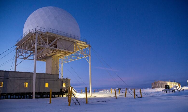 A giant white ball atop a staircase over Arctic snow