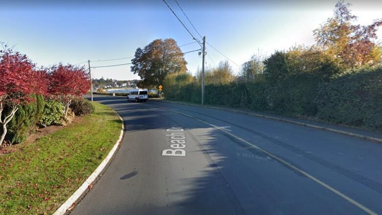 An expanse of road with bushes on either side and the word Beach down the centre of the road lifted from Google Street View.