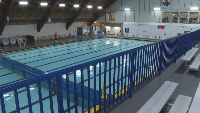 A swimming pool inside a recreation building.