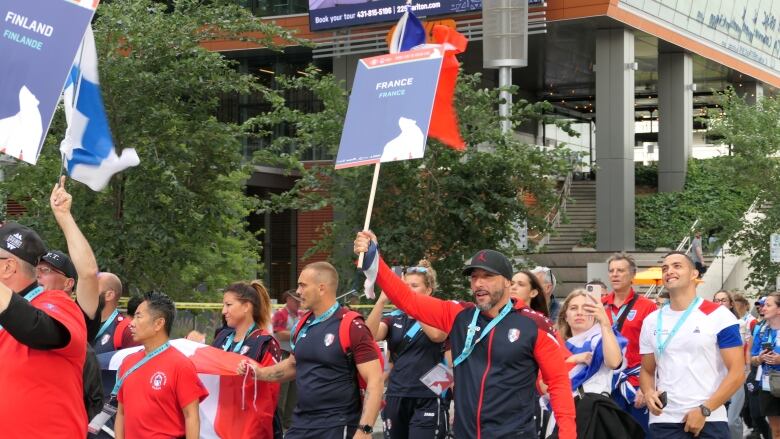 A man holds up a sign that says 