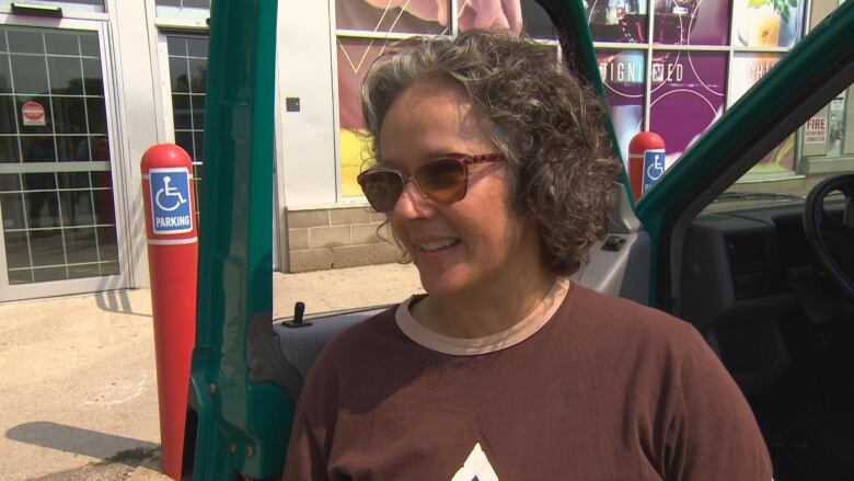 A woman in a brown shirt. 