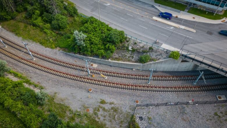 An overhead view of train tracks in summer