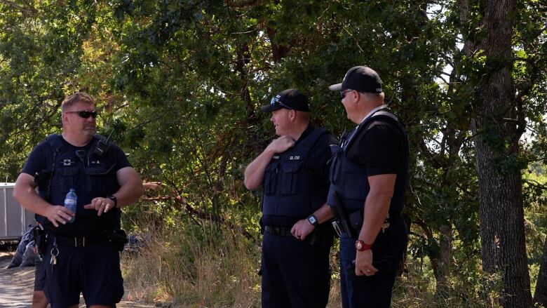 Barry Hornby, the Sr. Community Safety Officer, he chats with his team during the clean up. 