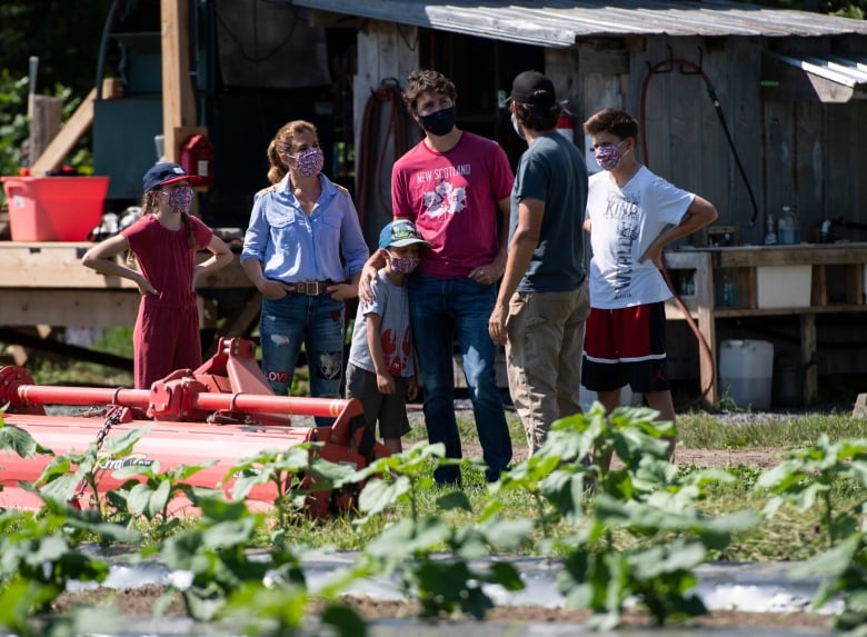 The Trudeau family listens to Community Harvest Manager Jason Gray before harvesting vegetables at the Ottawa Food Bank Farm in Ottawa, on Canada Day, Wednesday, July 1, 2020, in the midst of the COVID-19 pandemic.